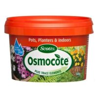 A tub of Osmocote Controlled Release Fertiliser: Pots, Planters & Indoors 500g, perfect for use in pots, planters, and indoors. The packaging is predominantly red with vibrant images of flowers.