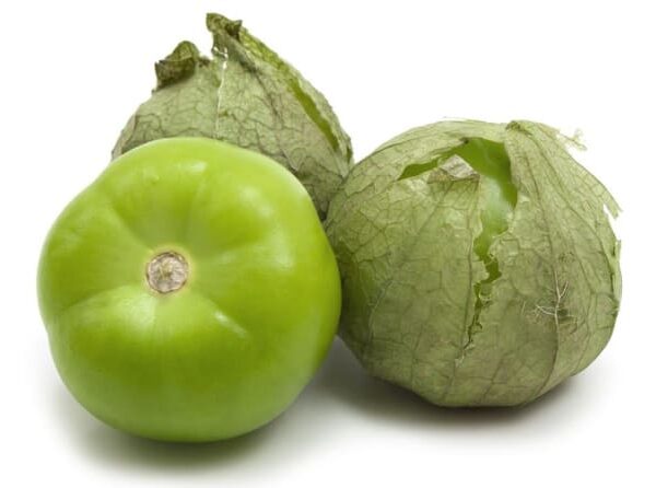 Three tomatillos, with two partially in husks, are set against a white background.