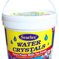 A 2.25 kg container of Searles Water Crystals is designed to water plants when needed and enhance plant growth. Perfect for your Corylus 'Crazy Filbert' in an 8" pot, the container is white with a yellow label and blue water droplet illustrations.