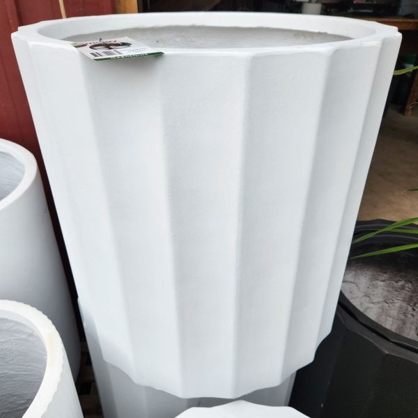 The GardenLite Grecian Cylinder White S 39x39cm planter stands upright with a price tag on its rim, displayed next to other similar-sized pots.