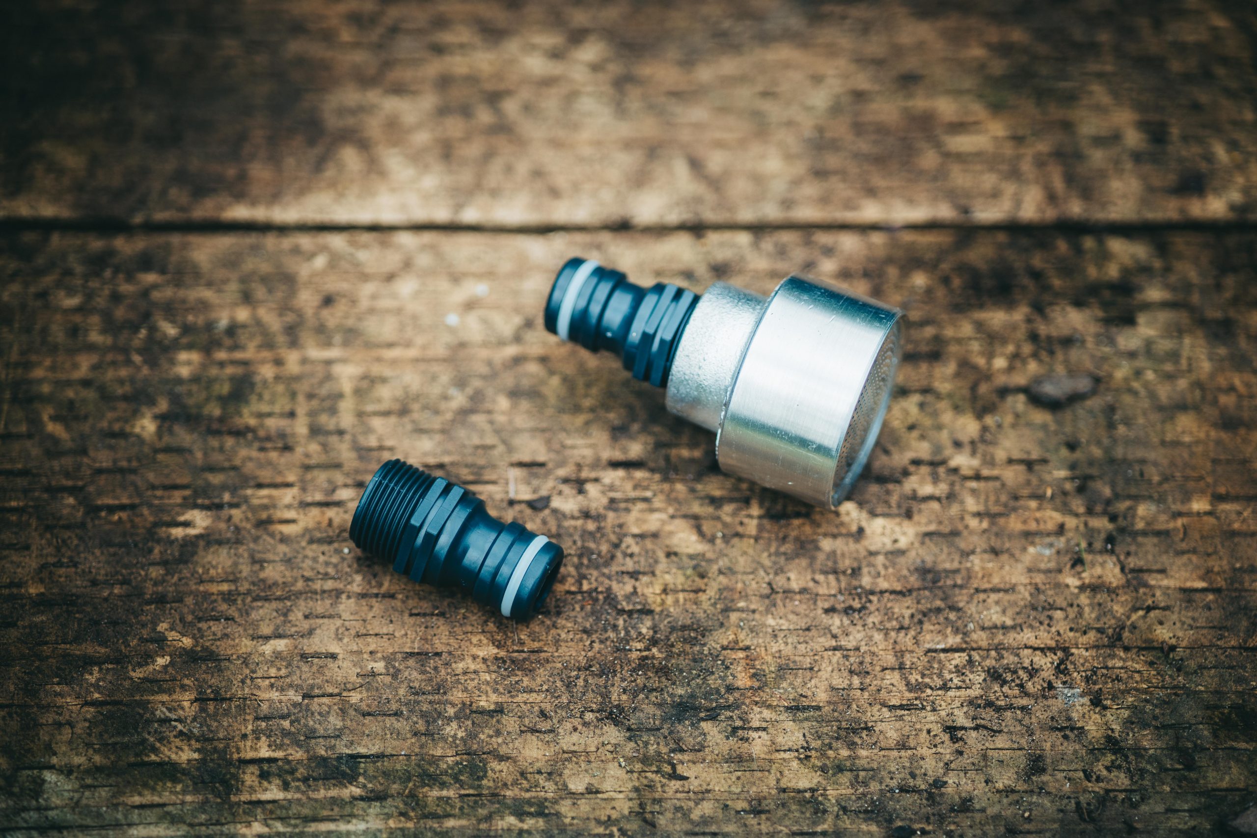 A pair of High Flow Rosette Head with Fittings 12mm, on a wooden surface.
