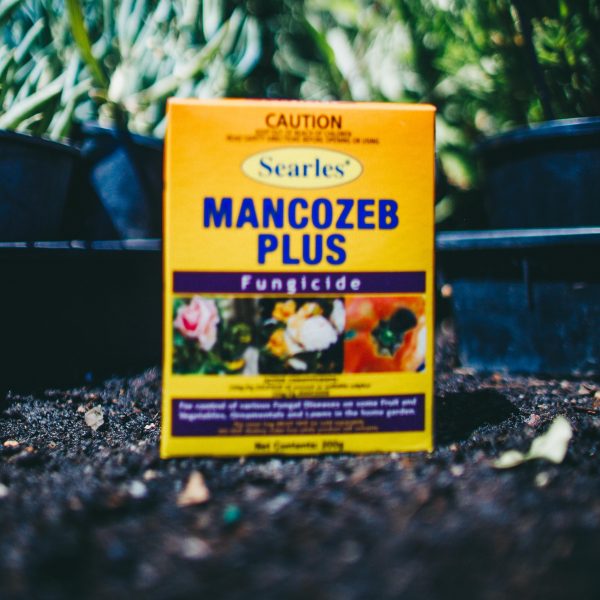 A box of Searles Mancozeb Plus Fungicide 200g sitting on the ground.