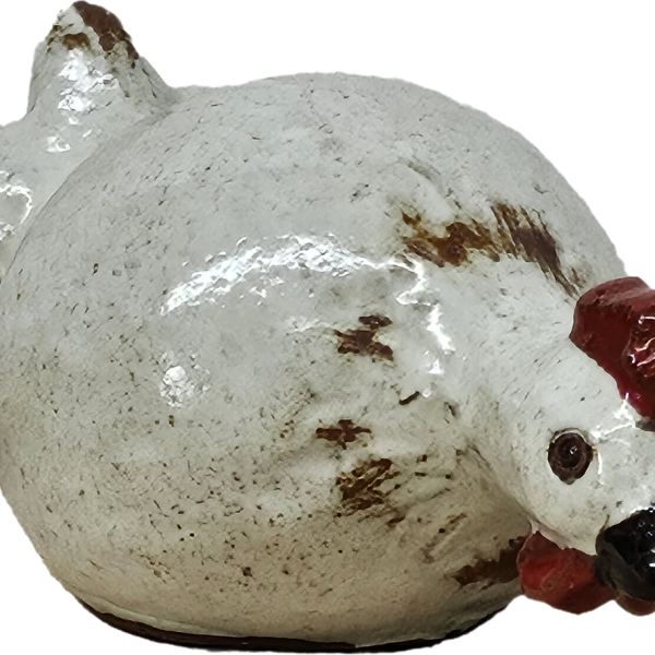 A charming ceramic chicken sculpture with a white body, brown speckles, and a red comb and wattle evokes rustic decor. Its elegant profile mirrors that of the classic Portica Dog Rust Decor L 19x14x23cm.