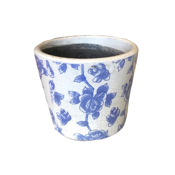 White ceramic pot with blue floral patterns on the surface.