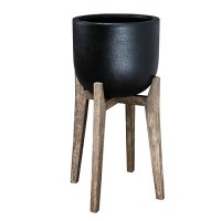 Black pot on a wooden stand with four angled legs.