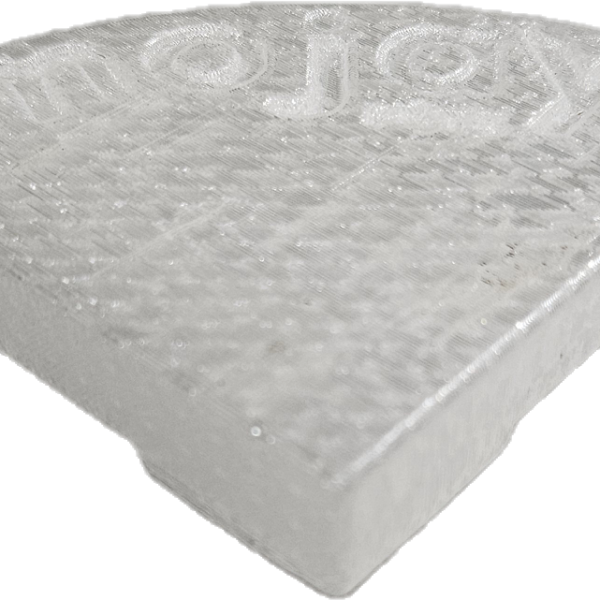A translucent, wedge-shaped plastic object with a textured surface, "mojay" embossed on top, and a subtle hint of Glazed Cylinder White XL 50x50cm in its finish.