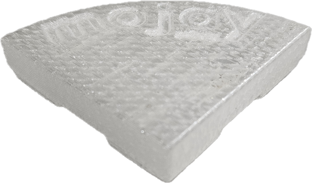 A translucent, wedge-shaped plastic object with a textured surface, "mojay" embossed on top, and a subtle hint of Glazed Cylinder White XL 50x50cm in its finish.