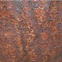 Close-up of a rusted metal surface, showing a rough texture with varying shades of brown, orange, and dark spots.