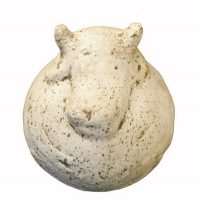 A round, speckled, white sculpture resembling the head of a hippopotamus, viewed from above against a plain background.