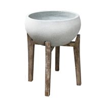 A round, light grey UrbanStyle Bowl Cement 35x23cm planter sits on a rustic wooden tripod stand against a white background.