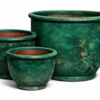 Three green ceramic flower pots of varying sizes are arranged together on a white background.