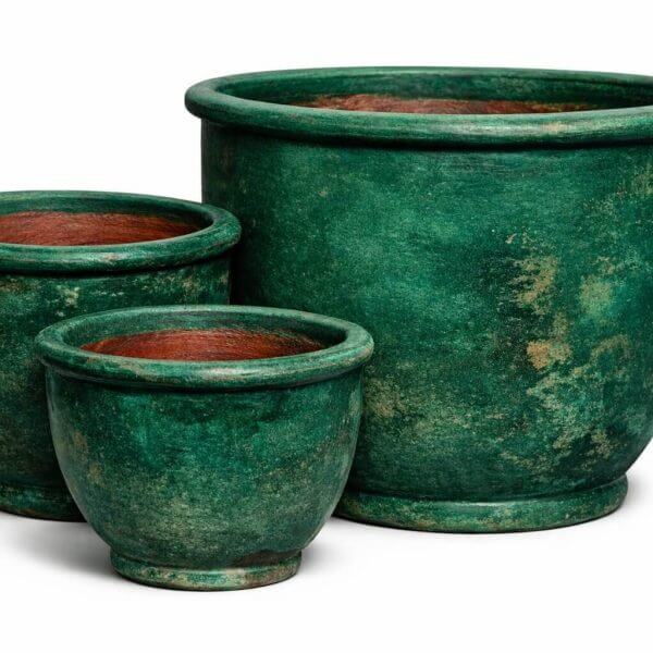 Three green ceramic flower pots of varying sizes are arranged together on a white background.