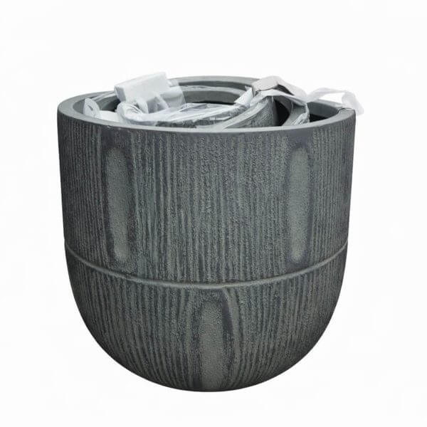 A medium, empty GardenLite Torino Tapered Planter Rust with textured sides and packaging materials inside, shown against a plain white background.
