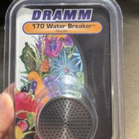 A hand holds a packaged DRAMM 170 Water Breaker Nozzle, featuring a metal spray head and colourful floral artwork on the label.