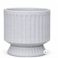 A white, round planter with vertical ridges and a flared base, displayed against a plain background.