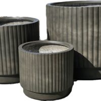 A set of three empty, ribbed Balmoral Corrugated Cylinder Black planters in varying sizes is displayed together against a white background.