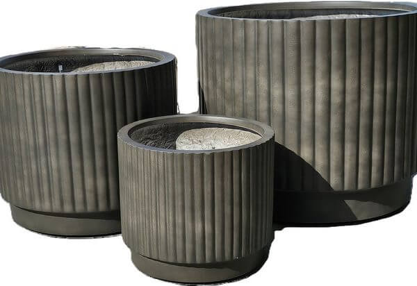A set of three empty, ribbed Balmoral Corrugated Cylinder Black planters in varying sizes is displayed together against a white background.
